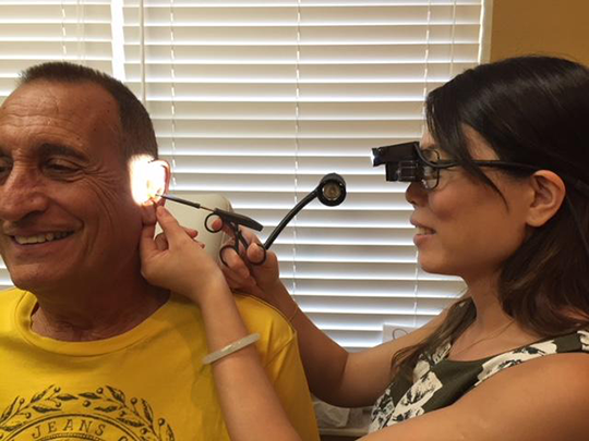 Audiologist, Nancy Wong,  working with a hearing loss patient. 